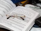 eyeglasses on open book
